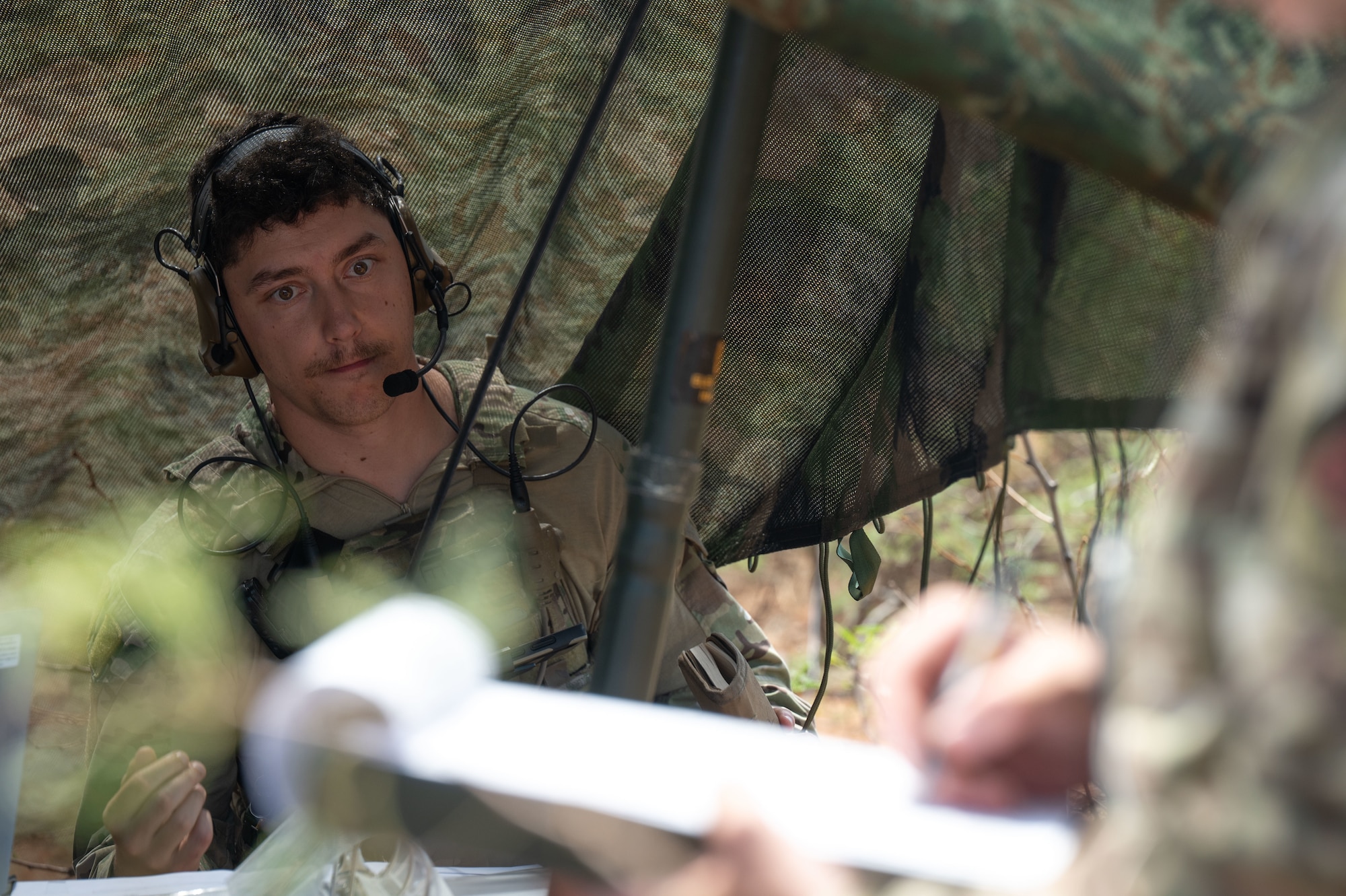 SSgt David Shisler, 14th Air Support Operations Squadron joint terminal attack controller, observes his evaluation during exercise Desert Dragon in Pearce, Arizona, July 31, 2025. Exercise Desert Dragon provided JTACs an opportunity to apply their skills in the field and to accomplish yearly training requirements. (U.S. Air Force photo by Airman Jaden Kidd)