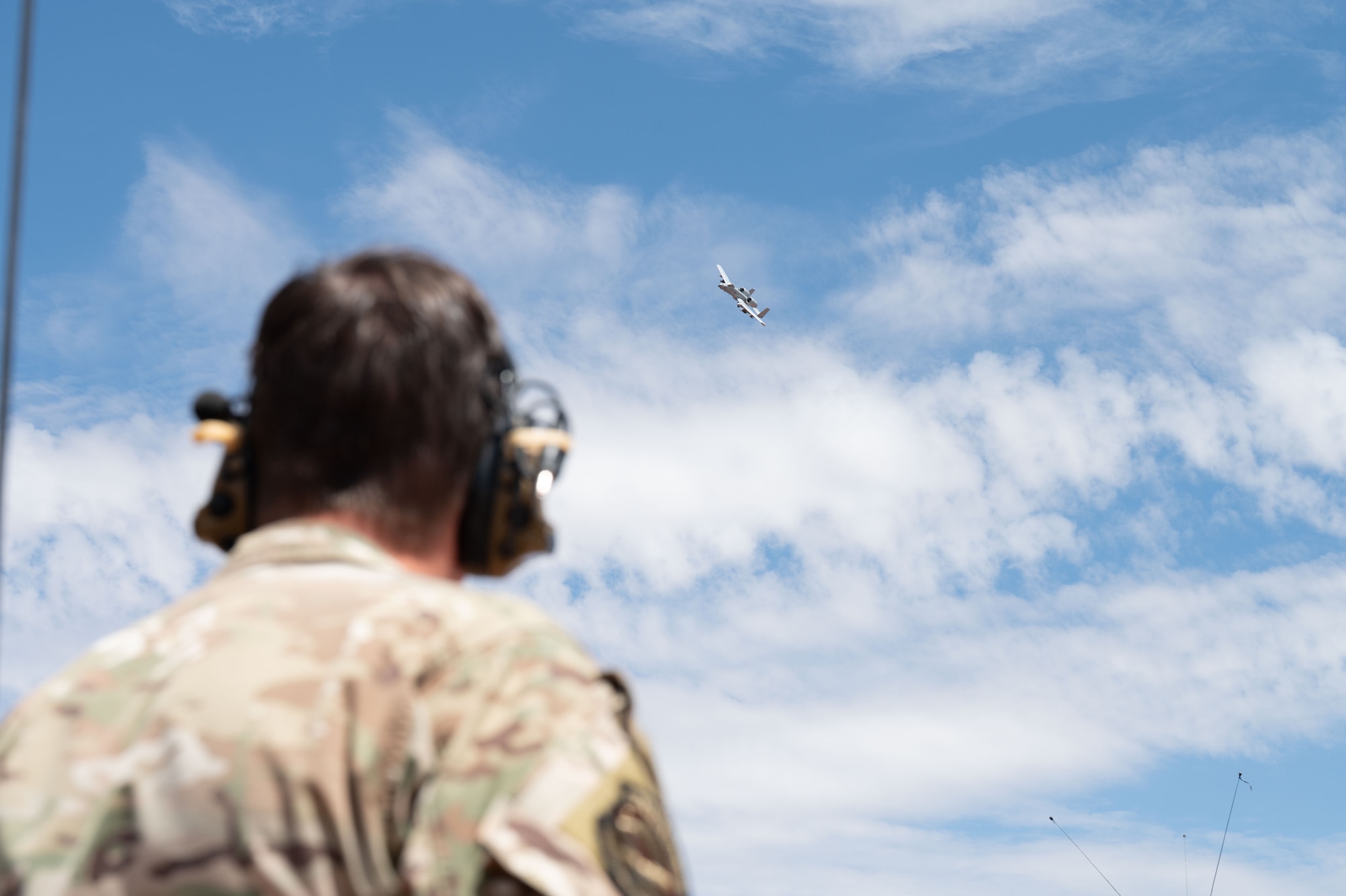 U.S. Air Force Master Sgt. Christopher Bechtold, 14th Air Support Operation Squadron flight chief, watches an aircraft pilot conduct a show of force after exercise Desert Dragon in Pearce, Arizona, July 31, 2025. Exercise Desert Dragon provided JTACs an opportunity to apply their skills in the field and to accomplish yearly training requirements. (U.S. Air Force photo by Airman Jaden Kidd)