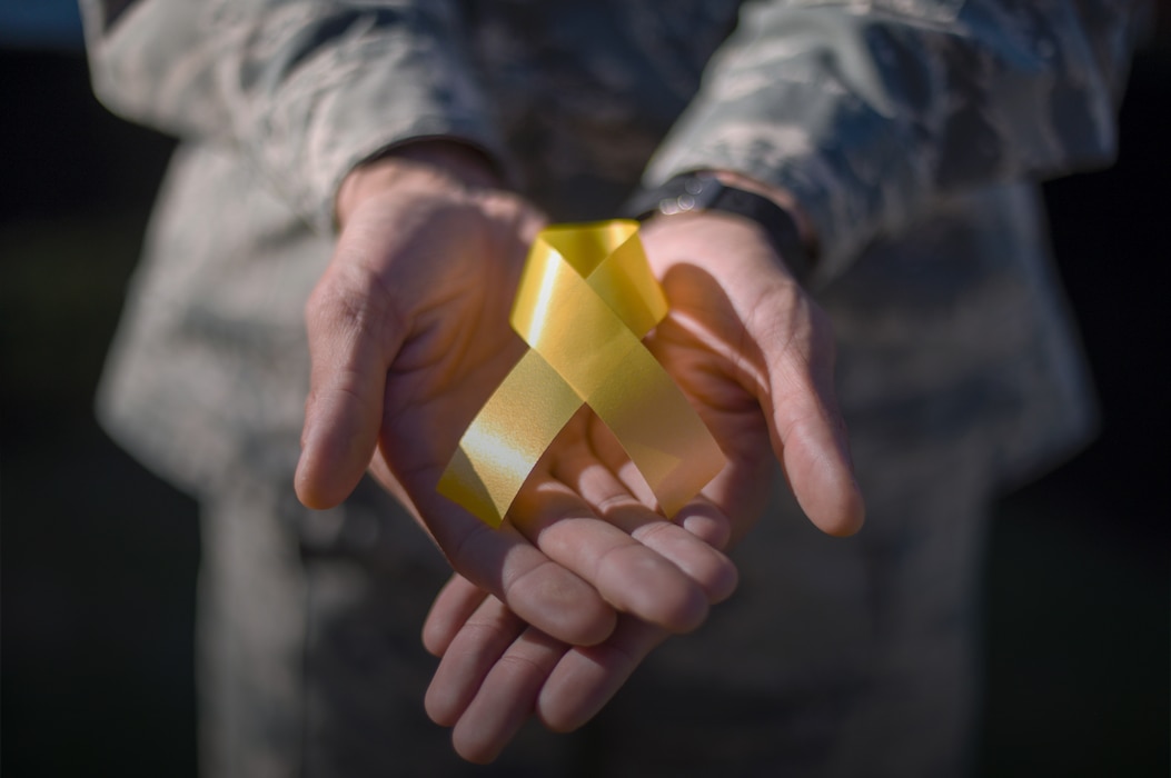 Airman holding yellow ribbon