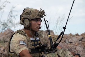 U.S. Air Force Staff Sgt. Christopher Benetti, 14th Air Support Operations Squadron joint terminal attack controller, uses communication equipment during exercise Desert Dragon in Pearce, Arizona, July 31, 2025. Benetti acted as the link between two ground force commanders and an aircraft pilot to accomplish exercise objectives. (U.S. Air Force photo by Airman Jaden Kidd)