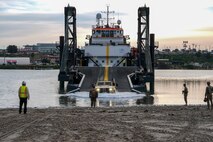 A Joint Light Tactical Vehicle drives off of the ramp of a Stern Landing Vessel, a modified oil-rig industry off-shore support vessel, in order to transport personnel off of the vessel as part of Project Convergence Capstone Four, Feb. 23, 2024 at the Del Mar Boat Basin, Camp Pendleton, CA. The Marine Corps Warfighting Laboratory contracted the SLV to experiment with maneuver and sustainment options for Stand-In Forces to inform the development of the Medium Landing Ship (LSM). PC-C4 is an Army-hosted, all-Service and multinational experiment. During PC-C4, the Marine Corps Warfighting Laboratory tested new technologies and capabilities and emerging concepts, including the multi-domain corridor. Marine Corps participation in PC-C4 supported Force Design initiatives, integrated Joint force and coalition capabilities into experimentation, and demonstrated the Marine Corps' commitment to the Joint Warfighting Concept. (U.S. Marine Corps photo by Kevin Ray J. Salvador)
