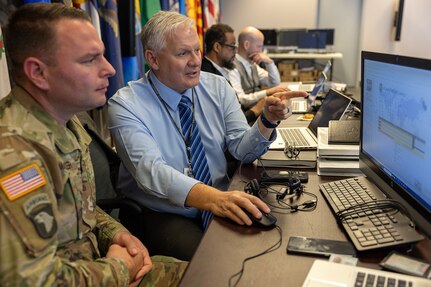 Mark Burton, U.S. Army Financial Management Command Operations director, talks with Maj. Andy Mach-Miller, USAFMCOM operations officer, during a staff exercise at the Maj. Gen. Emmett J. Bean Federal Center in Indianapolis Oct. 28, 2024. USAFMCOM hosted the exercise to increase its operational capabilities through the four phases of the conflict continuum, reduce its inefficiencies in battle tasks, and clearly identify financial management roles, responsibilities and authorities. (U.S. Army photo by Mark R. W. Orders-Woempner)