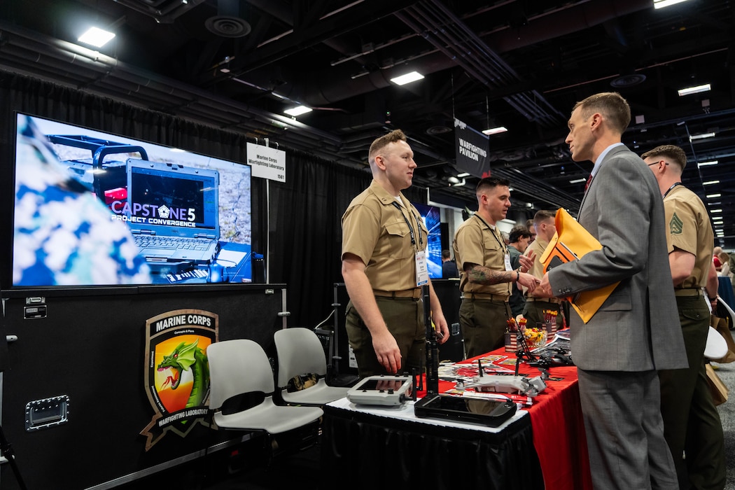 Members of the Marine Corps Warfighting Laboratory, man MCWL's booth during Modern Day Marine at the Walter E. Washington Convention Center, Washington D.C., April 29th, 2025. Modern Day Marine is a military exposition exclusively organized for the Marine Corps to showcase the newest technology and warfighting innovations from amphibious assault vehicles to drones and more. (U.S. Marine Corps photo by Connor Taggart)