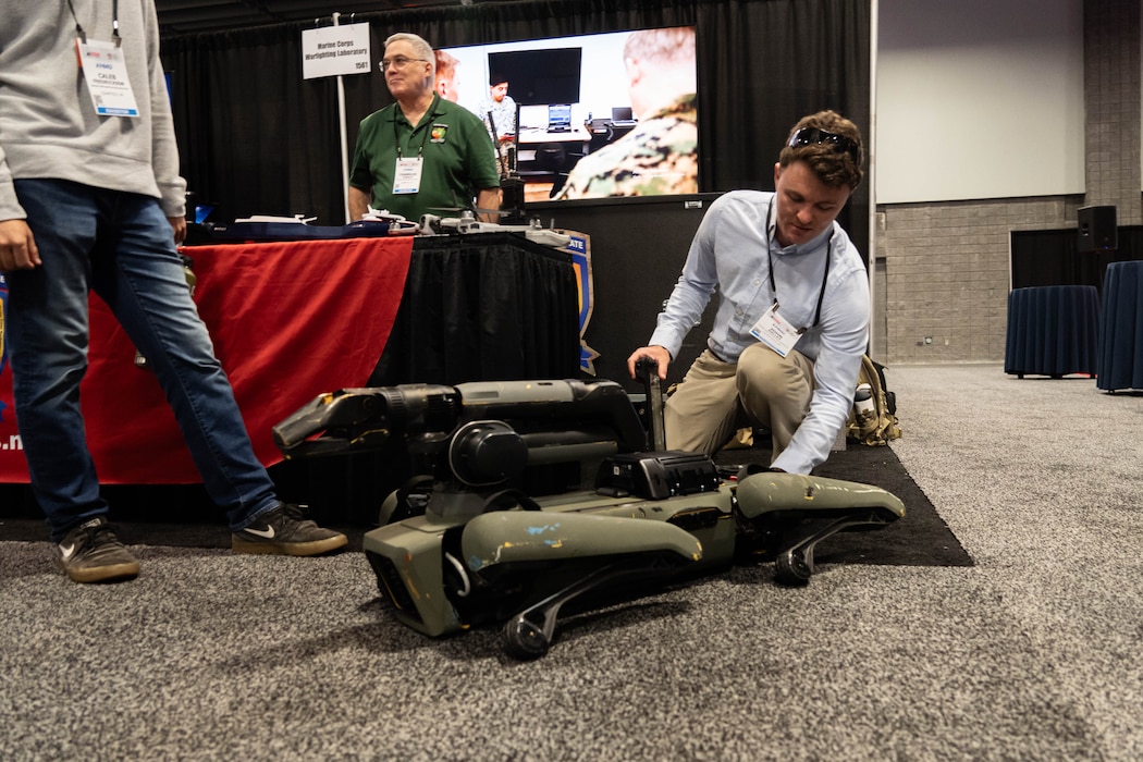 Mr. John Kelley, Marine Corps Warfighting Laboratory, demonstrates the capabilities of a robot dog, during Modern Day Marine at the Walter E. Washington Convention Center, Washington D.C., April 30th, 2025. Modern Day Marine is a military exposition exclusively organized for the Marine Corps to showcase the newest technology and warfighting innovations from amphibious assault vehicles to drones and more. (U.S. Marine Corps photo by Connor Taggart)