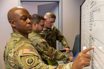 Maj. Deon Carter, 45th Finance Center Team B officer in charge and banking officer from Schofield Barracks, Hawaii, marks a board during a staff exercise at the Maj. Gen. Emmett J. Bean Federal Center in Indianapolis Oct. 28, 2024. The U.S. Army Financial Management Command hosted the exercise to increase its operational capabilities through the four phases of the conflict continuum, reduce its inefficiencies in battle tasks, and clearly identify financial management roles, responsibilities and authorities. (U.S. Army photo by Mark R. W. Orders-Woempner)