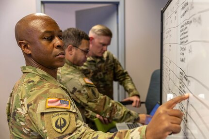 Maj. Deon Carter, 45th Finance Center Team B officer in charge and banking officer from Schofield Barracks, Hawaii, marks a board during a staff exercise at the Maj. Gen. Emmett J. Bean Federal Center in Indianapolis Oct. 28, 2024. The U.S. Army Financial Management Command hosted the exercise to increase its operational capabilities through the four phases of the conflict continuum, reduce its inefficiencies in battle tasks, and clearly identify financial management roles, responsibilities and authorities. (U.S. Army photo by Mark R. W. Orders-Woempner)