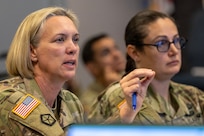 Col. Michelle M. Williams, U.S. Army Financial Management Command commander, provides direction at a battle update brief as Sgt. Maj. Julie Harris, USAFMCOM Operations senior enlisted advisor, listens on during a staff exercise at the Maj. Gen. Emmett J. Bean Federal Center in Indianapolis Oct. 30, 2024. USAFMCOM hosted the exercise to increase its operational capabilities through the four phases of the conflict continuum, reduce its inefficiencies in battle tasks, and clearly identify financial management roles, responsibilities and authorities. (U.S. Army photo by Mark R. W. Orders-Woempner)