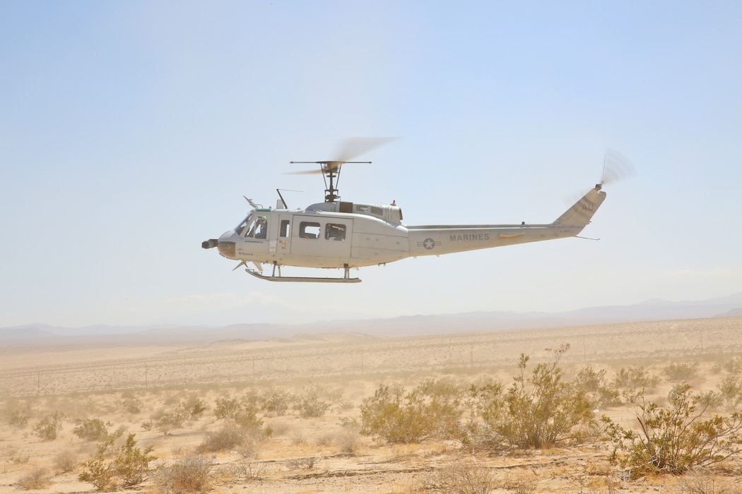 Autonomous Aerial Cargo Utility System (AACUS) provides a material resupply for Marines assigned to Combat Logistics Battalion 8, based at Marine Corps Base Camp Lejeune, NC during the Marine Corps Warfighting Lab Expeditionary Hybrid Logistics experiment conducted in conjunction with Integrated Training Exercise 3-18 at Marine Air Ground Combat Center, Twentynine Palms, CA, May 14, 2018. During this experiment, AACUS successfully conducted multiple resupply missions of varying distance and payload, and received fuel from a forward aerial refuel point (FARP). Both events were firsts for the program.