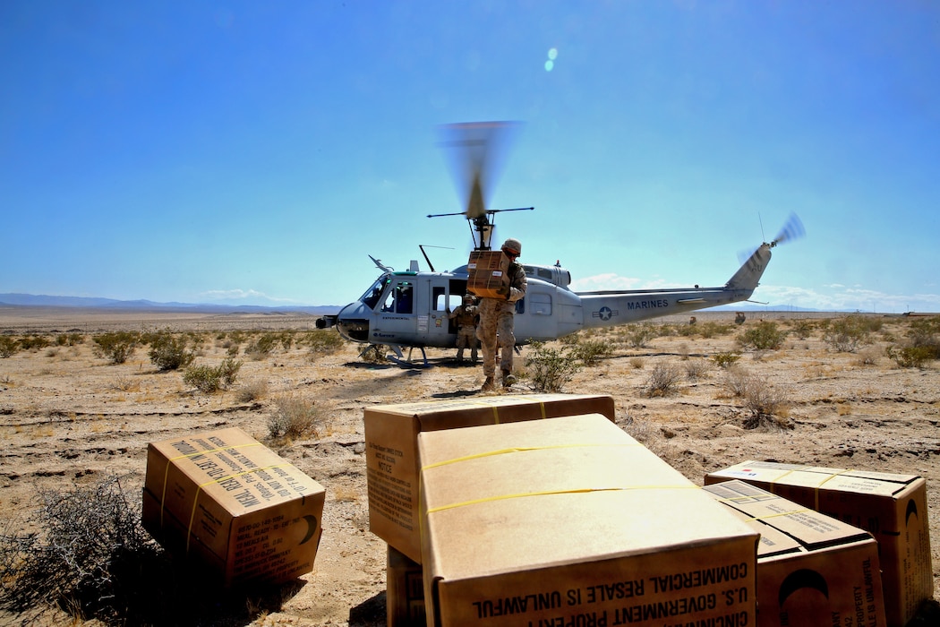 Autonomous Aerial Cargo Utility System (AACUS) provides a material resupply for Marines assigned to Combat Logistics Battalion 8, based at Marine Corps Base Camp Lejeune, NC during the Marine Corps Warfighting Lab Expeditionary Hybrid Logistics experiment conducted in conjunction with Integrated Training Exercise 3-18 at Marine Air Ground Combat Center, Twentynine Palms, CA, May 14, 2018. During this experiment, AACUS successfully conducted multiple resupply missions of varying distance and payload, and received fuel from a forward aerial refuel point (FARP). Both events were firsts for the program.