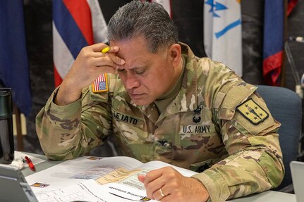 Col. Rob Le’iato, U.S. Army Finance and Comptroller School commandant, reviews documents during a staff exercise at the Maj. Gen. Emmett J. Bean Federal Center in Indianapolis Oct. 31, 2024. The U.S. Army Financial Management Command hosted the exercise to increase its operational capabilities through the four phases of the conflict continuum, reduce its inefficiencies in battle tasks, and clearly identify financial management roles, responsibilities and authorities. (U.S. Army photo by Mark R. W. Orders-Woempner)