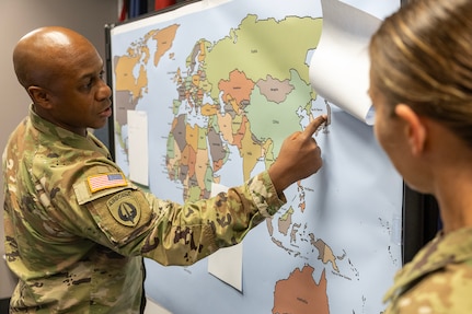 Maj. Deon Carter, 45th Finance Center Team B officer in charge and banking officer from Schofield Barracks, Hawaii, has a discussion with Maj. Sonja Keith, 45th FC Chief of Operations, during a staff exercise at the Maj. Gen. Emmett J. Bean Federal Center in Indianapolis Oct. 30, 2024. The U.S. Army Financial Management Command hosted the exercise to increase its operational capabilities through the four phases of the conflict continuum, reduce its inefficiencies in battle tasks, and clearly identify financial management roles, responsibilities and authorities. (U.S. Army photo by Mark R. W. Orders-Woempner)