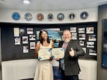 Two people holding certificates