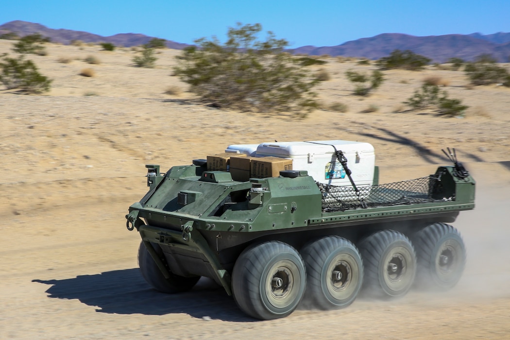 A Mission Master unmanned ground vehicle cruises through the desert as part of an unmanned logistics convoy at Marine Corps Air-Ground Combat Center, Twentynine Palms, California, Oct. 19, 2023. The Mission Master by Rheinmetall was designed for the purpose of increasing logistical flexibility in the field. (U.S. Marine Corps photo by Kevin Ray J. Salvador)