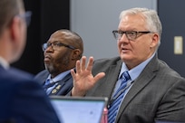 Mark Burton, U.S. Army Financial Management Command Operations director, gives remarks during a staff exercise as Gennaro Penn, USAFMCOM Military Pay Operations Readiness Division manager, listens on at the Maj. Gen. Emmett J. Bean Federal Center in Indianapolis Oct. 28, 2024. USAFMCOM hosted the exercise to increase its operational capabilities through the four phases of the conflict continuum, reduce its inefficiencies in battle tasks, and clearly identify financial management roles, responsibilities and authorities. (U.S. Army photo by Mark R. W. Orders-Woempner)