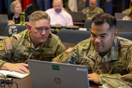 Sgt. 1st Class Nathan James, 45th Finance Center Team A internal control advisor, and Maj. Danny Duarte, 45th FC Team A officer in charge, both from Fort Knox Kentucky, work through injects during a staff exercise at the Maj. Gen. Emmett J. Bean Federal Center in Indianapolis Oct. 28, 2024. The U.S. Army Financial Management Command hosted the exercise to increase its operational capabilities through the four phases of the conflict continuum, reduce its inefficiencies in battle tasks, and clearly identify financial management roles, responsibilities and authorities. (U.S. Army photo by Mark R. W. Orders-Woempner)
