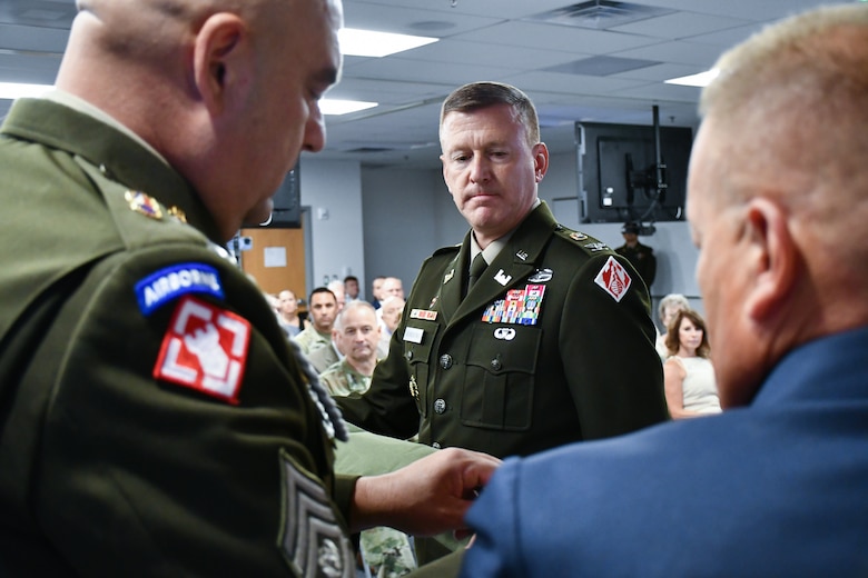 U.S. Army Col. Craig S. Baumgartner, U.S. Army Corps of Engineers Transatlantic Division commander (center), Command Sgt. Maj. Michael Arroyo, division senior enlisted advisor (left), and Scott Sawyer, Programs and Business chief (right), case the division colors during a Transfer of Authority ceremony in Winchester, Virginia, Aug. 5, 2025. The ceremony marked the transition of mission oversight for U.S. Central Command support from the Transatlantic Division to the U.S. Army Corps of Engineers Southwestern Division.