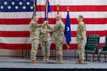U.S. Army Maj. Gen. Gregory Knight, the adjutant general of Vermont, presents the guidon of the Vermont Air National Guard to U.S. Air Force Brig. Gen. David Shevchik Jr., the incoming commander, during a change of command ceremony at Camp Johnson, Colchester, Vermont, Aug. 1, 2025. The ceremony represents the seamless transition of leadership from one commanding officer to another, signifying the trust in the new commander to lead and guide the command, ensuring success in fulfilling their mission. (U.S. Air National Guard photo by Senior Master Sgt. Michael Davis)