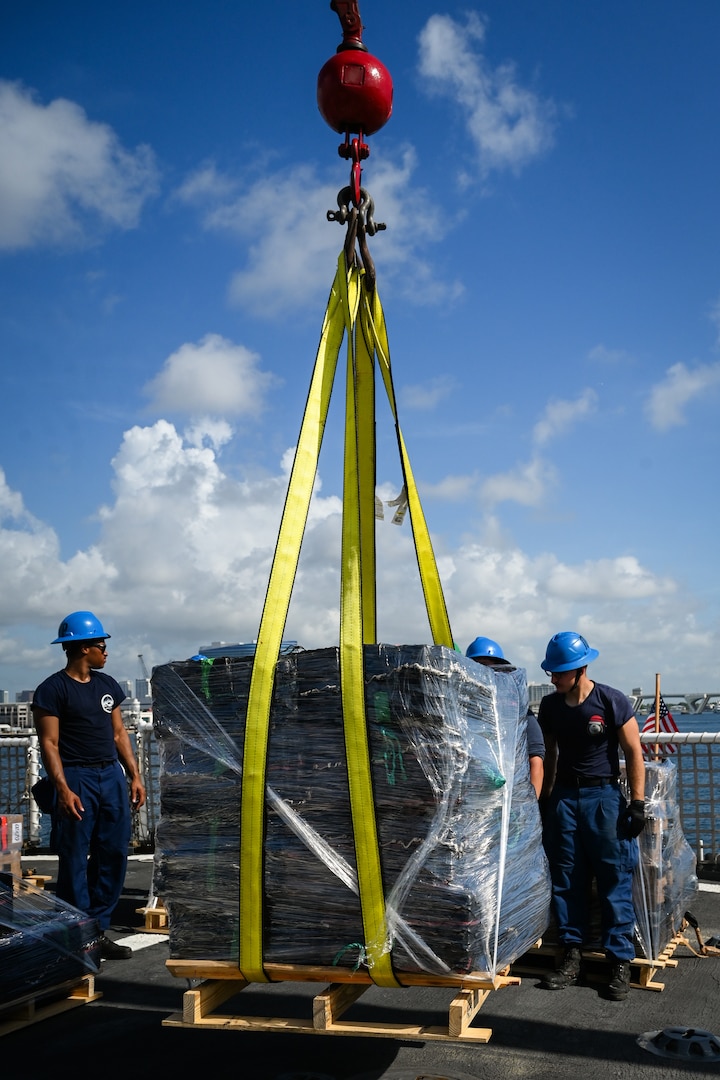 The crew of U.S. Coast Guard Escanaba transferring a pallet of interdicted narcotics to shore at Port Everglades, Florida, August 5, 2025. The Coast Guard routinely patrols the eastern Pacific in support of counter-drug operations. (U.S. Coast Guard photo by Petty Officer 3rd Class Nicholas Strasburg)