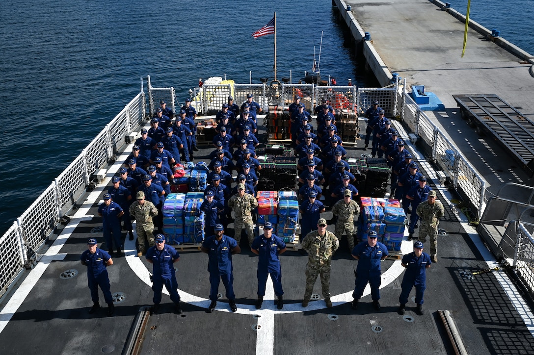 The crew of the U.S. Coast Guard Cutter Escanaba standing at parade rest on the flight deck at Port Everglades, Florida, August 5, 2025. The seized contraband was transferred to partner agencies for accountability and destruction. (U.S. Coast Guard photo by Petty Officer 3rd Class Jessica Walker)