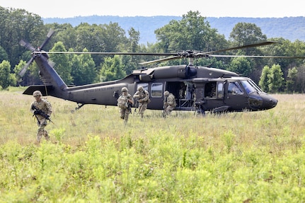 U.S. Soldiers with Charlie Company, 1st Battalion, 109th Infantry Regiment exit a UH-60 Black Hawk helicopter during an exercise at Fort Indiantown Gap, Pennsylvania, July 29, 2025. The Soldiers trained in an intensive 96 hour force-on-force exercise to simulate combat against a capable adversary. (U.S. Army National Guard photo by Staff Sgt. Zachery Jockel)