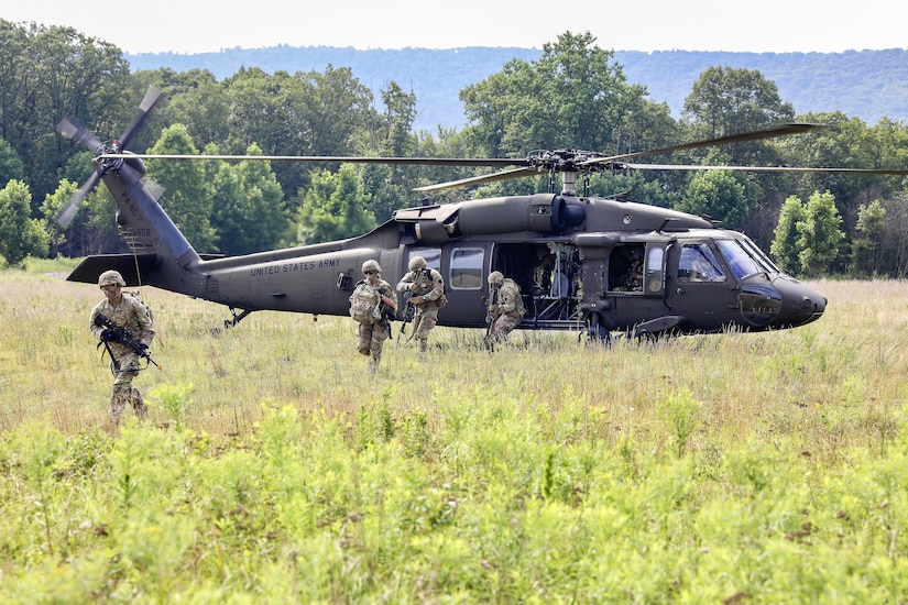 U.S. Soldiers with Charlie Company, 1st Battalion, 109th Infantry Regiment exit a UH-60 Black Hawk helicopter during an exercise at Fort Indiantown Gap, Pennsylvania, July 29, 2025. The Soldiers trained in an intensive 96 hour force-on-force exercise to simulate combat against a capable adversary. (U.S. Army National Guard photo by Staff Sgt. Zachery Jockel)