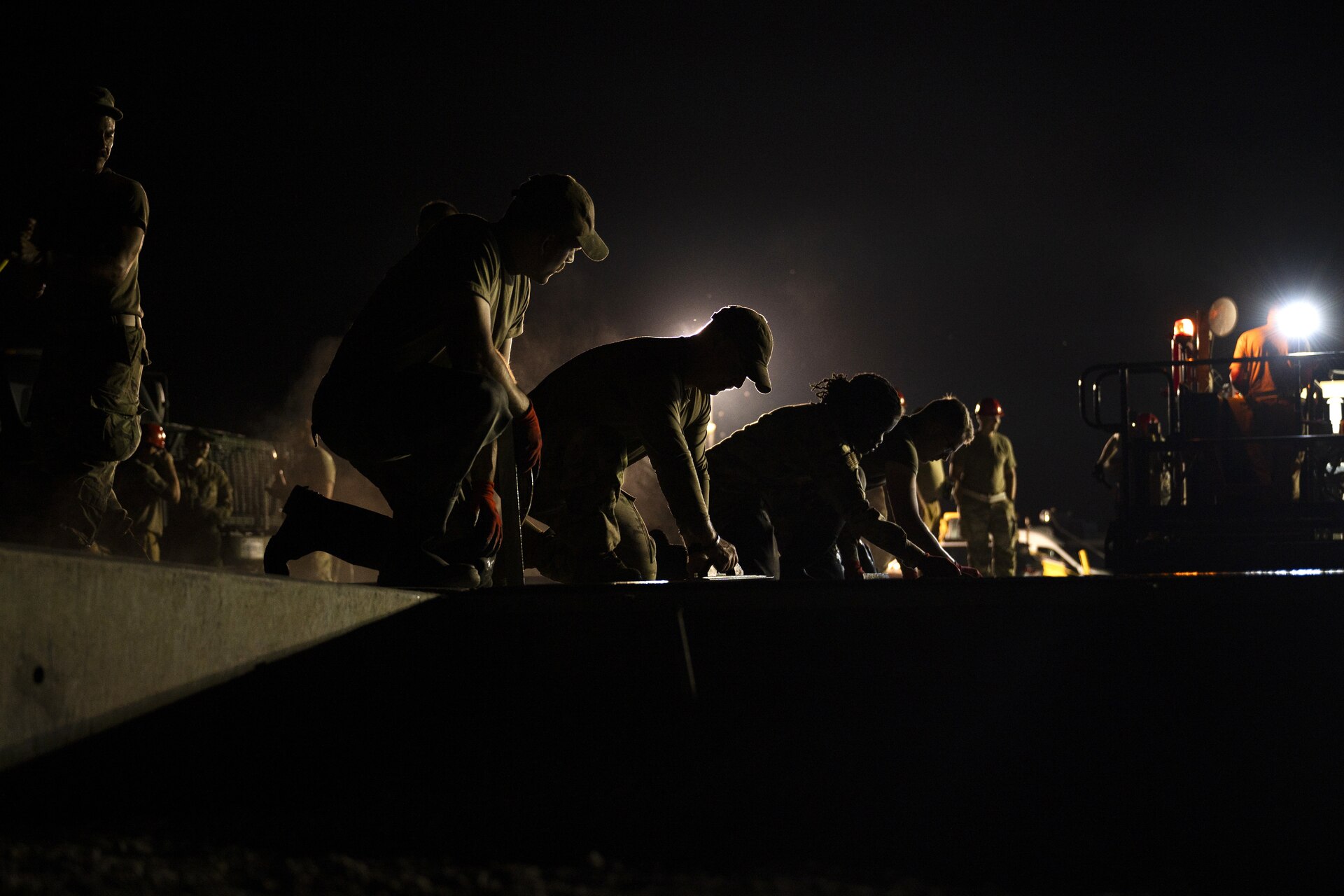 Airmen from the 157th Civil Engineer Squadron Prime Base Engineer Emergency Force smooth 250 cubic yards of concrete at the 201st Regional Training Site, Fort Indiantown Gap, Pennsylvania, July 30, 2025. Five separate sections of the CES honed their prime base engineer emergency force skills, ensuring readiness to open, sustain, and recover the base across contingency operations, emergency responses, and recovery missions. (U.S. Air National Guard photo by Tech. Sgt. Victoria Nelson)