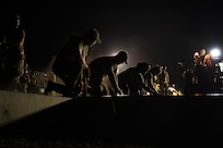 Airmen from the 157th Civil Engineer Squadron Prime Base Engineer Emergency Force smooth 250 cubic yards of concrete at the 201st Regional Training Site, Fort Indiantown Gap, Pennsylvania, July 30, 2025. Five separate sections of the CES honed their prime base engineer emergency force skills, ensuring readiness to open, sustain, and recover the base across contingency operations, emergency responses, and recovery missions. (U.S. Air National Guard photo by Tech. Sgt. Victoria Nelson)