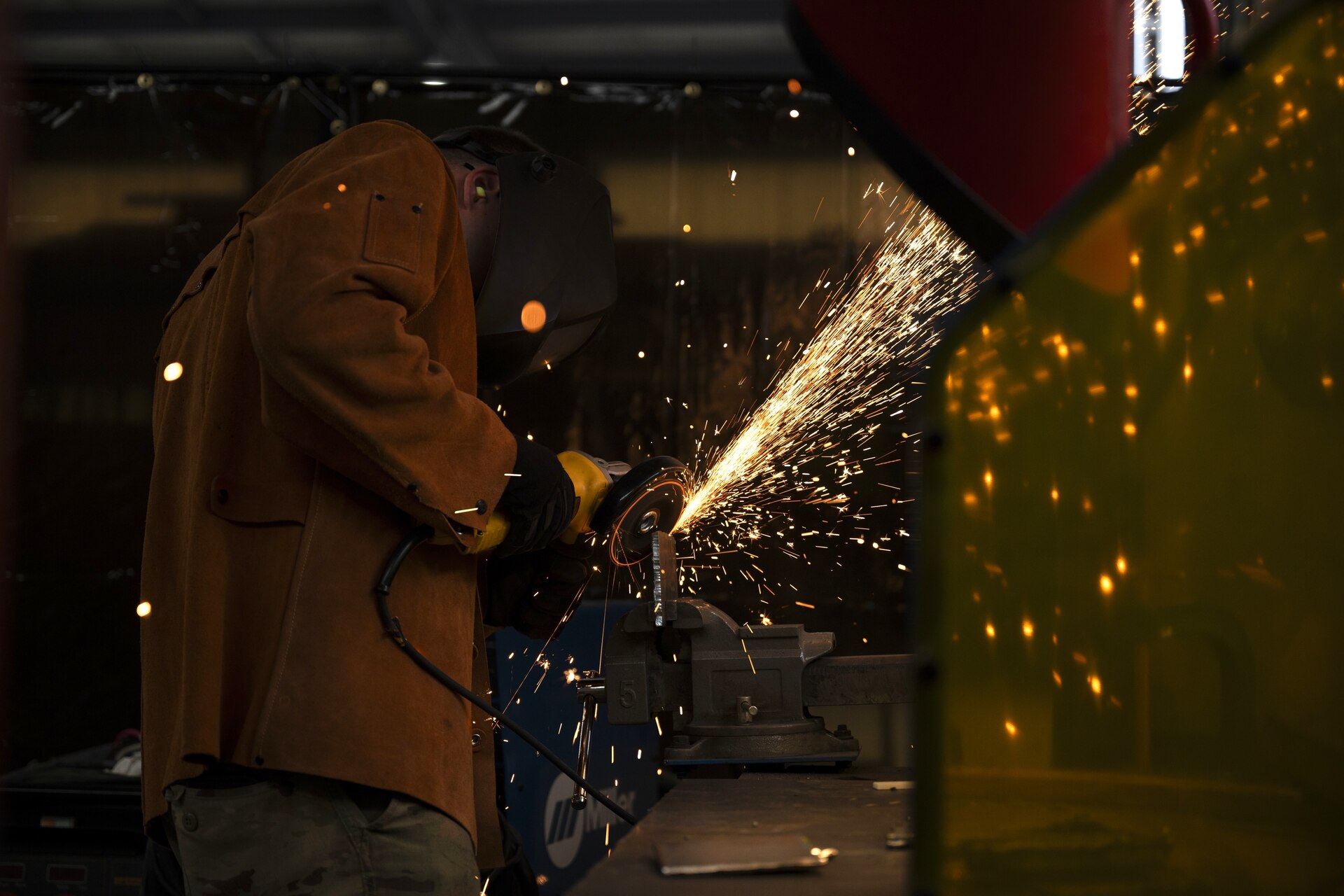 Tech. Sgt. Alan Bauman, structures NCO in charge with the 157th Civil Engineer Squadron, grinds a metal plate during a weeklong base engineer emergency force training at the 201st Regional Training Site, Fort Indiantown Gap, Pennsylvania, Aug. 1, 2025. The prime BEEF training sharpened expeditionary engineering skills in high-heat conditions, reinforcing mission readiness for rapid deployment environments. (U.S. Air National Guard photo by Tech. Sgt. Victoria Nelson)
