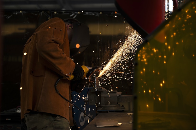 Tech. Sgt. Alan Bauman, structures NCO in charge with the 157th Civil Engineer Squadron, grinds a metal plate during a weeklong base engineer emergency force training at the 201st Regional Training Site, Fort Indiantown Gap, Pennsylvania, Aug. 1, 2025. The prime BEEF training sharpened expeditionary engineering skills in high-heat conditions, reinforcing mission readiness for rapid deployment environments. (U.S. Air National Guard photo by Tech. Sgt. Victoria Nelson)