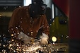 Senior Airman Collin Small, a structures specialist with the 157th Civil Engineer Squadron, grinds a metal plate during a week-long prime base engineer emergency force training at Fort Indiantown Gap, Pennsylvania, Aug. 1, 2025. The prime BEEF training sharpened expeditionary engineering skills in high-heat conditions, reinforcing mission readiness for rapid deployment environments. (U.S. Air National Guard photo by Tech. Sgt. Victoria Nelson)