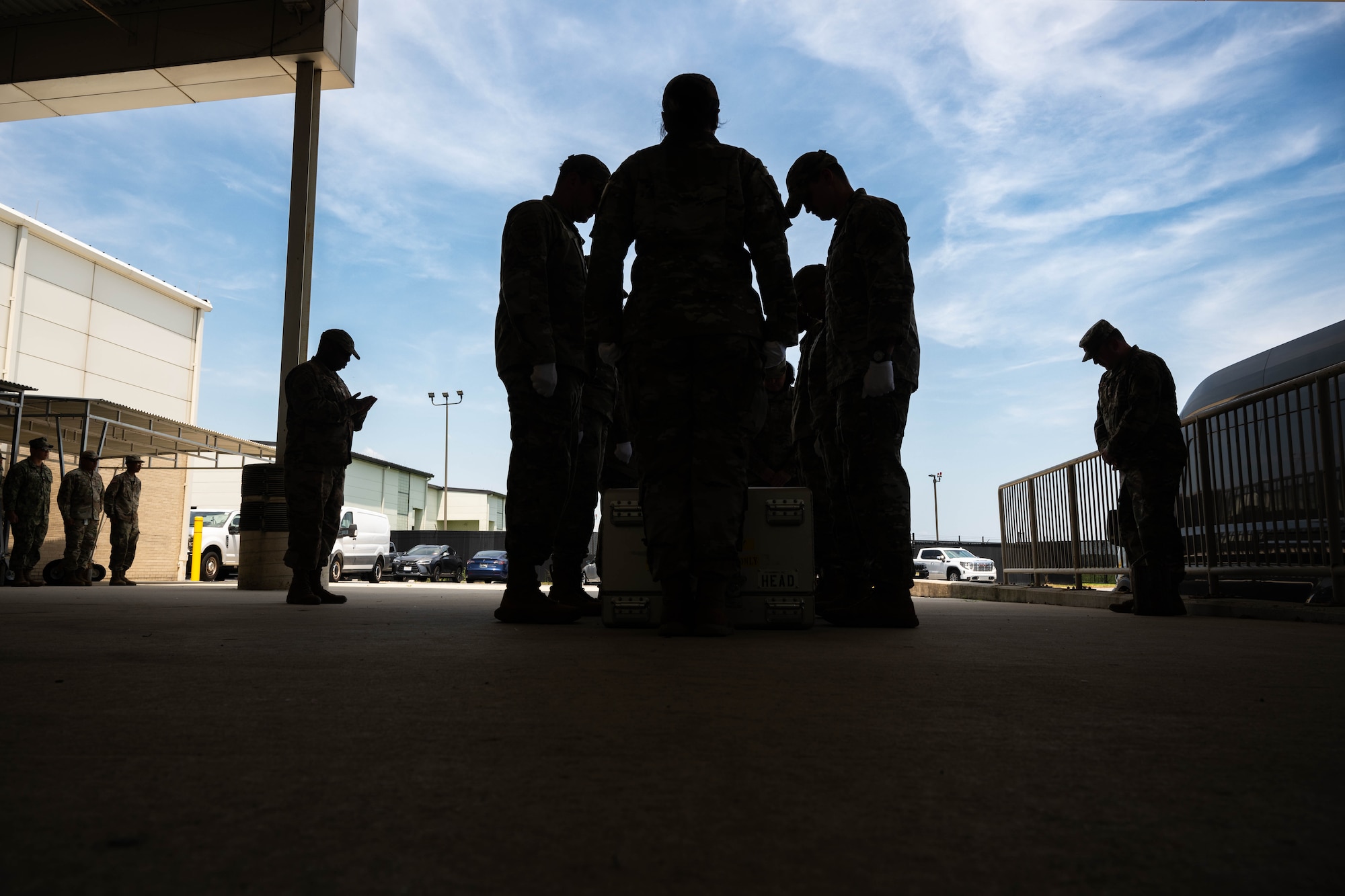 Airmen from Air Force Mortuary Affairs Operations participate in a prayer as a part of a mock dignified transfer during the Chaplain Corps Mortuary Training Course hosted by AFMAO at Dover Air Force Base, Delaware, July 29, 2025. The training prepares chaplains and religious support personnel to care for families of the fallen, covering topics such as the dignified transfer, grief counseling, and providing emotional and spiritual support. (U.S. Air Force photo by Senior Airman Madeline Baisey)