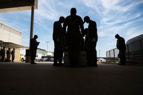 Airmen from Air Force Mortuary Affairs Operations participate in a prayer as a part of a mock dignified transfer during the Chaplain Corps Mortuary Training Course hosted by AFMAO at Dover Air Force Base, Delaware, July 29, 2025. The training prepares chaplains and religious support personnel to care for families of the fallen, covering topics such as the dignified transfer, grief counseling, and providing emotional and spiritual support. (U.S. Air Force photo by Senior Airman Madeline Baisey)