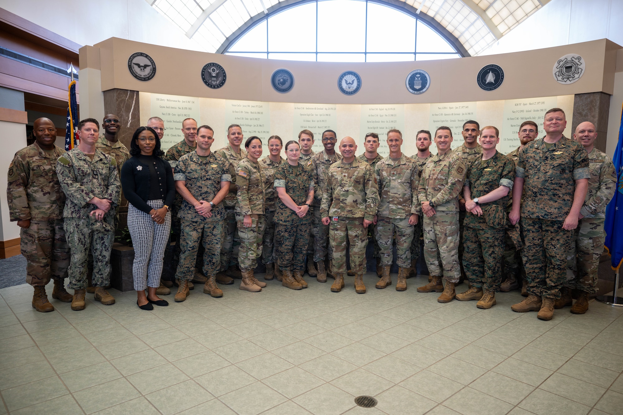 Attendees from the Chaplain Corps Mortuary Training Course hosted by Air Force Mortuary Affairs Operations chaplain team pose for a group photo in the atrium of AFMAO after an orientation at Dover Air Force Base, Delaware, July 30, 2025. The training prepares chaplains and religious support personnel to care for families of the fallen, covering topics such as the dignified transfer, grief counseling, and providing emotional and spiritual support. (U.S. Air Force photo by Senior Airman Madeline Baisey)