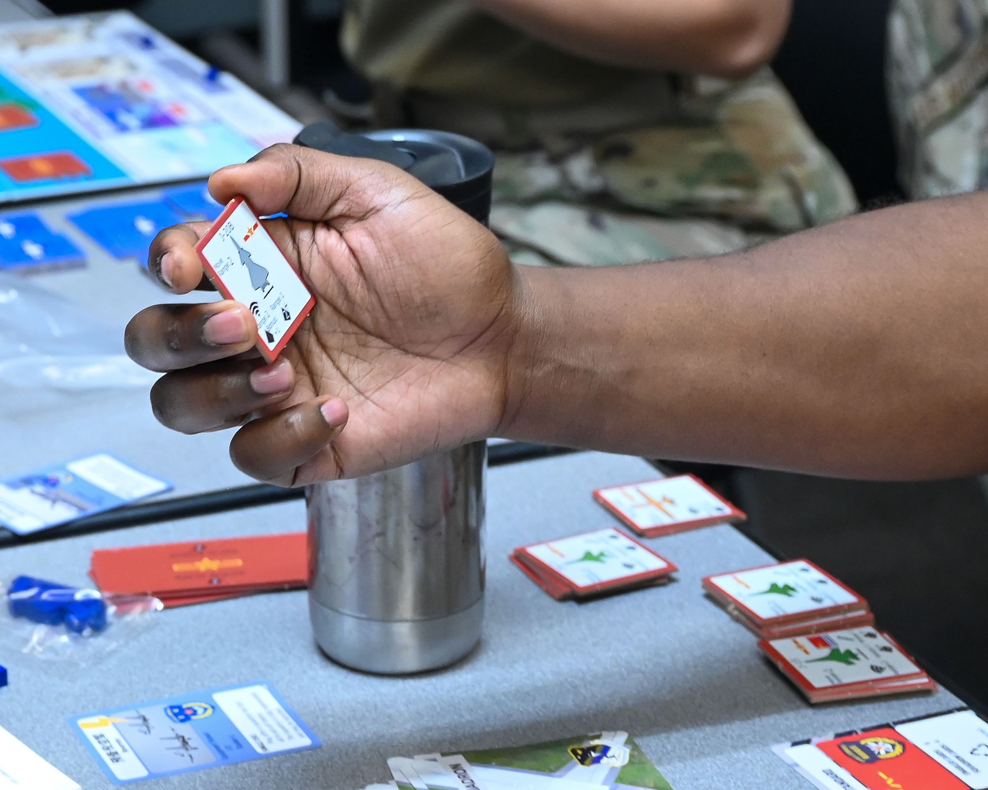 U.S. Air Force Maj. Quinton Kennedy, 30th Student Squadron, Squadron Officer School flight commander and instructor, holds a card while participating in an Air Force Wargame Indo-Pacific exercise at Maxwell Air Force Base, Alabama, July 22, 2025.