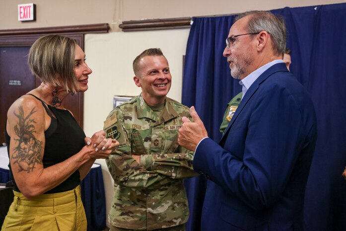 U.S. Air Force Chief Master Sgt. Steven Creek, 9th Reconnaissance Wing command chief, and spouse, Kat Creek, talk with CMSgt. Creek’s Honorary Commander, Paul Joiner.