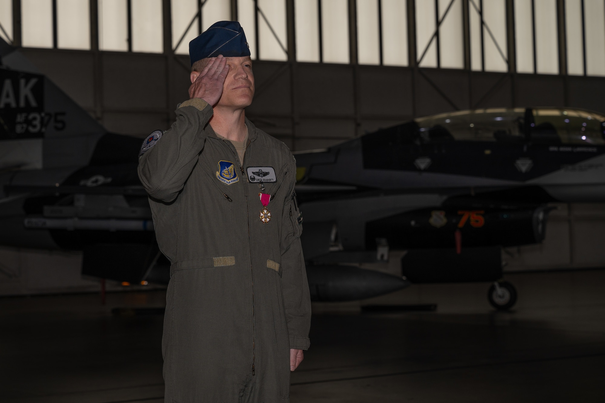 U.S. Air Force Col. Curtis Dougherty, 354th Operations Group outgoing commander, renders a final salute to the formation, during a change of command ceremony at Eielson Air Force Base, Alaska, Aug. 5, 2025.