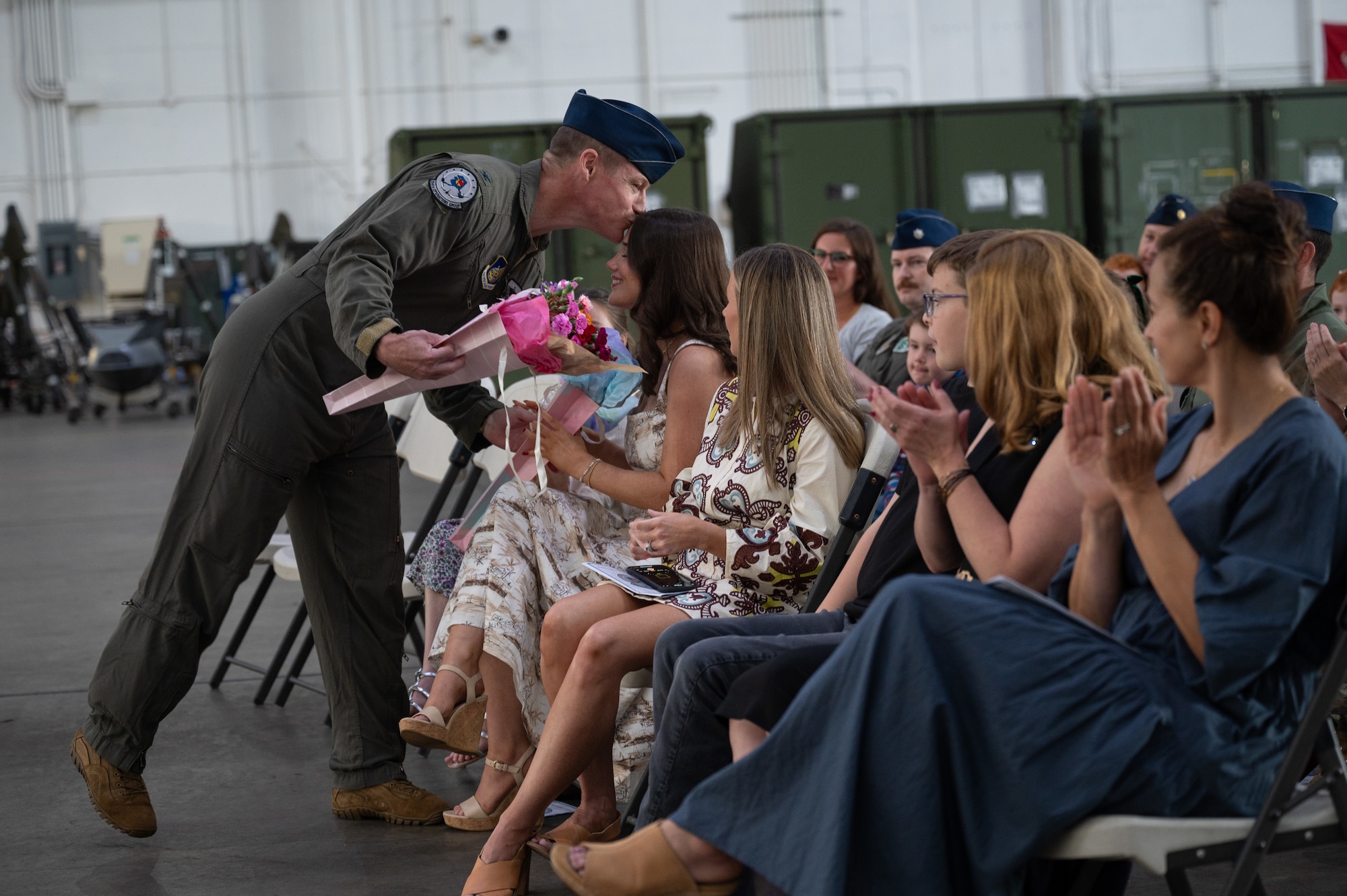U.S. Air Force Col. Curtis Dougherty, left, 354th Operations Group outgoing commander, gives flowers to his family at Eielson Air Force Base, Alaska, Aug. 5, 2025.