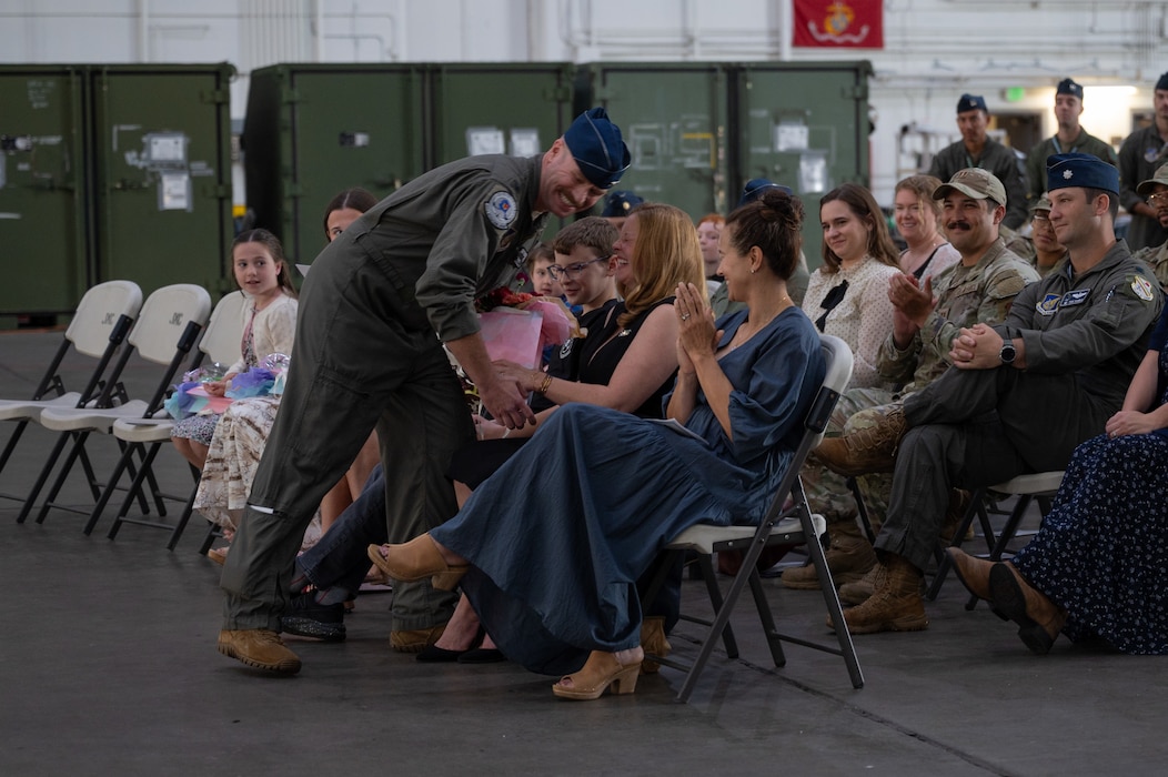 U.S. Air Force Col. Samuel Chipman, 354th Operations Group incoming commander, gives flowers to his family at Eielson Air Force Base, Alaska, Aug. 5, 2025.