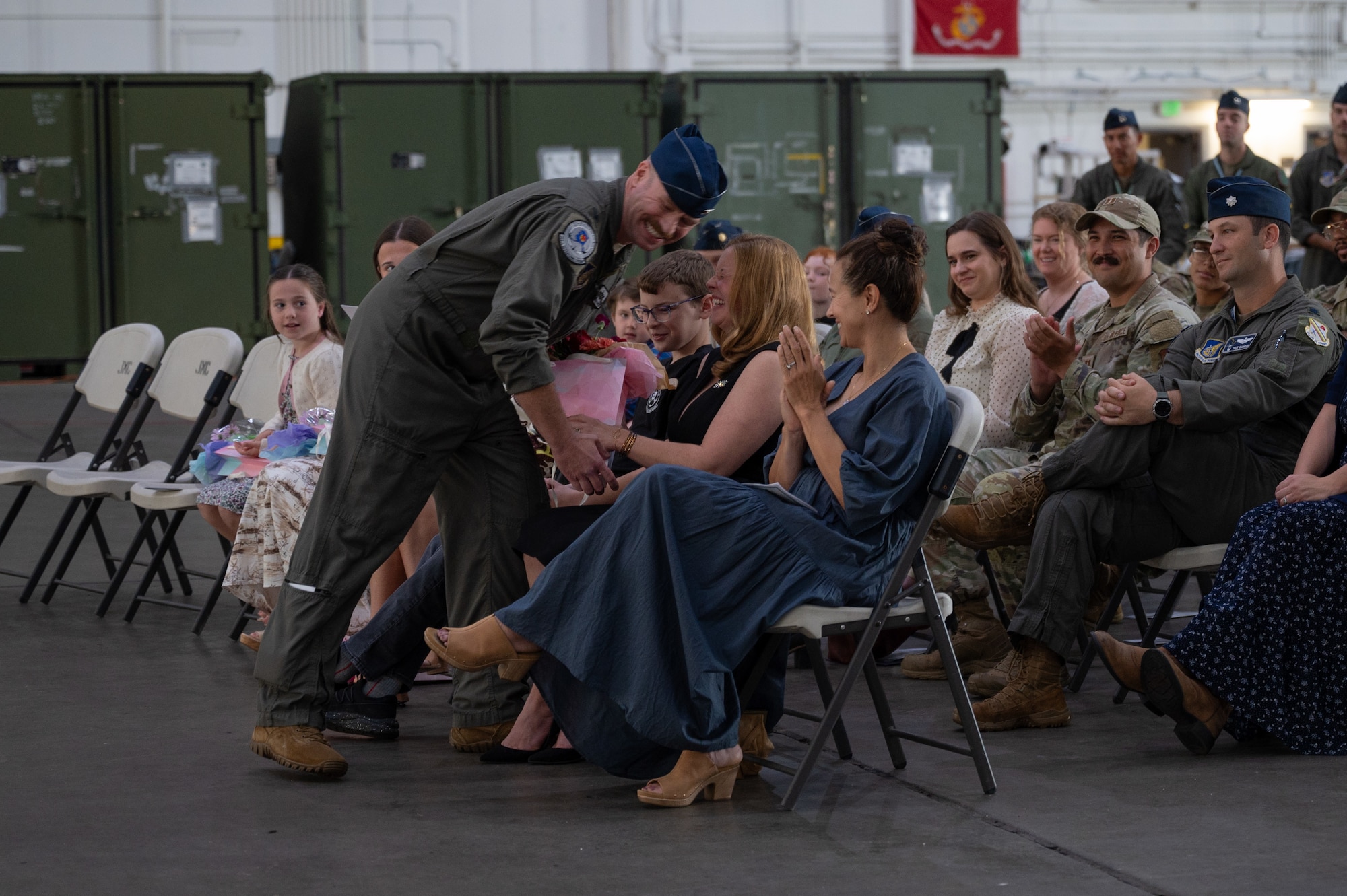 U.S. Air Force Col. Samuel Chipman, 354th Operations Group incoming commander, gives flowers to his family at Eielson Air Force Base, Alaska, Aug. 5, 2025.