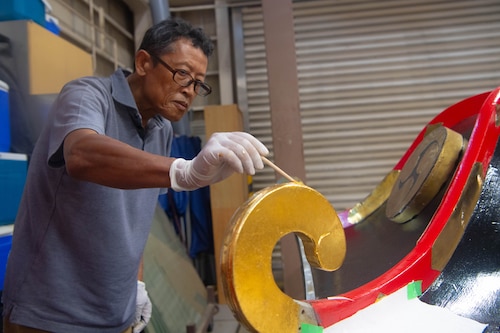 A man paints a roof.