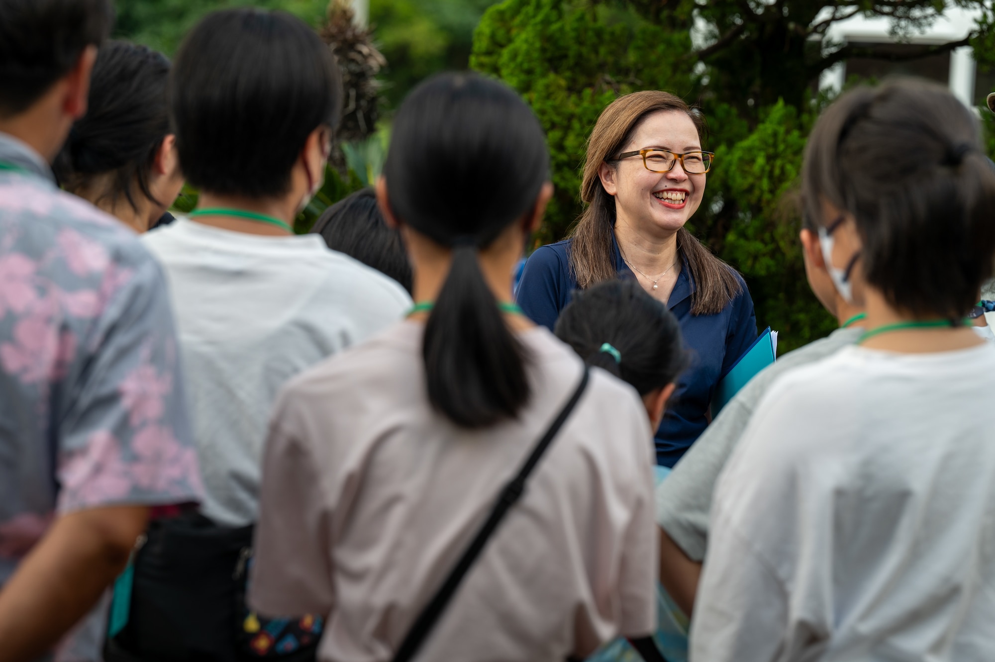 An 18th Wing Public Affairs member briefs Achi-Mura students on the Peace Garden at Kadena
