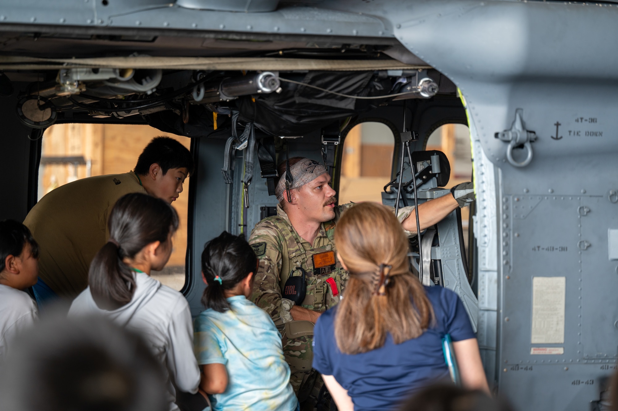 A 33rd Rescue Squadron pilot teaches Achi-Mura students about the HH-60W Jolly Green II