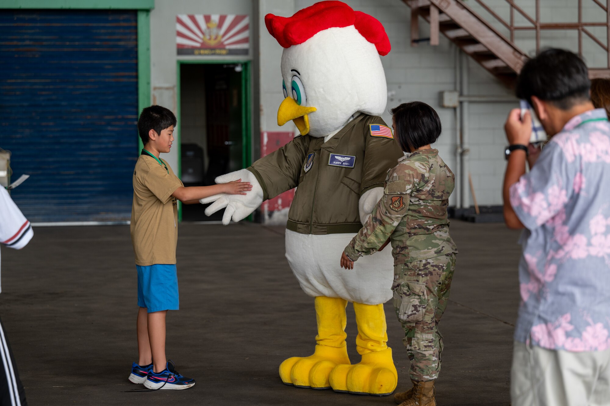Achi-Mura student greets 18th Wing mascot Kappy
