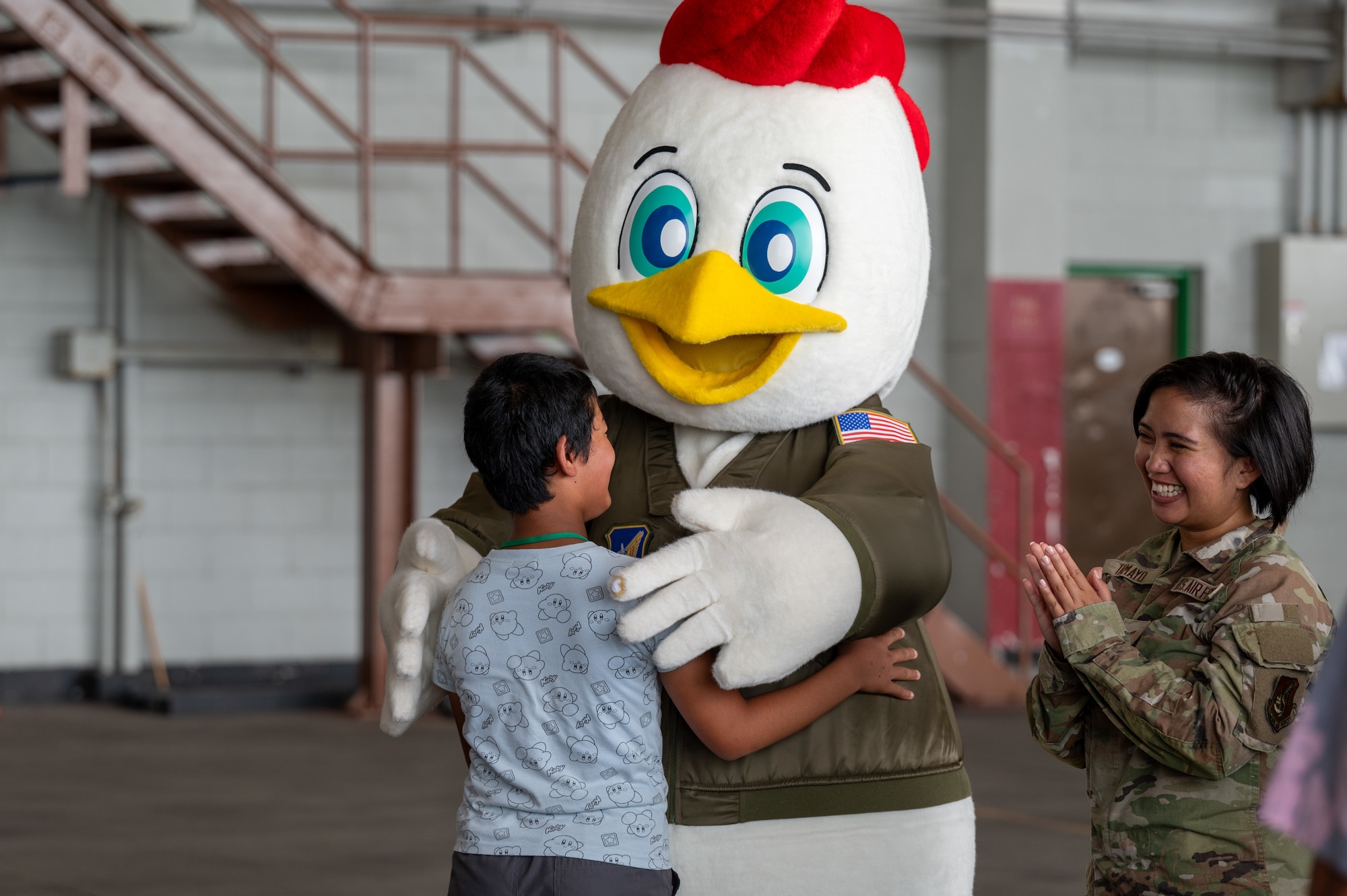 Achi-Mura student hugs the 18th Wing mascot Kappy
