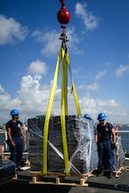 The crew of U.S. Coast Guard Escanaba transferring a pallet of interdicted narcotics to shore at Port Everglades, Florida, August 5, 2025. The Coast Guard routinely patrols the eastern Pacific in support of counter-drug operations. (U.S. Coast Guard photo by Petty Officer 3rd Class Nicholas Strasburg)