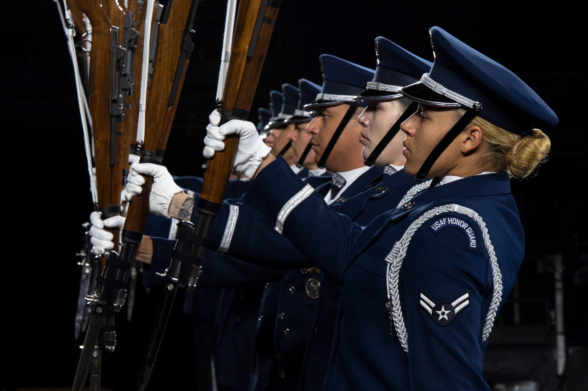 Members of the U.S. Air Force Honor Guard Drill Team conduct a Marine pitchout drill movement during the rehearsal of the 75th Royal Edinburgh Military Tattoo in Edinburgh, Scotland, July 31, 2025.