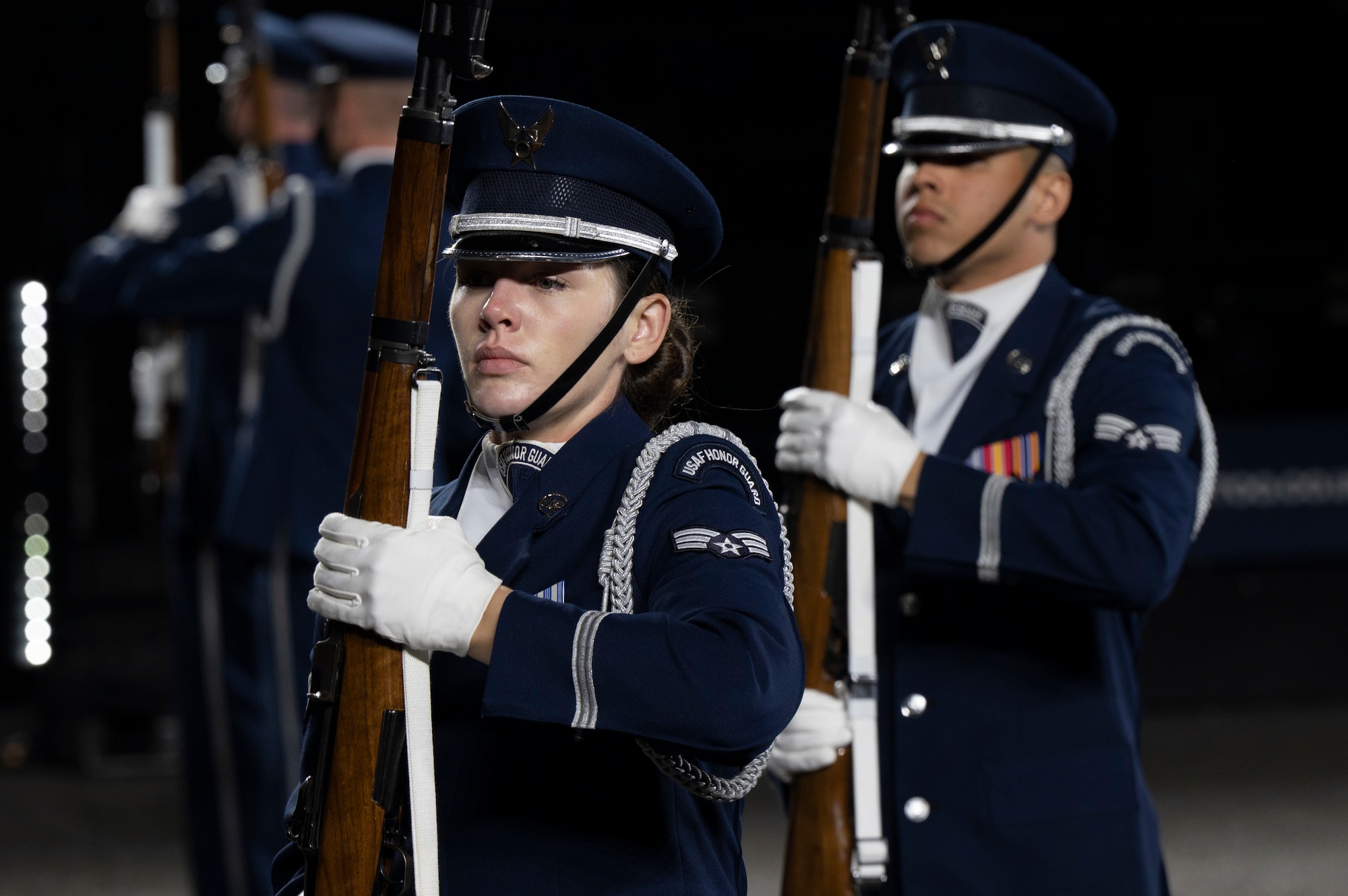 U.S. Air Force Senior Airman Sara Wilson, ceremonial guardsman with the U.S. Air Force Honor Guard, stands at port arms ready to execute a drill sequence during the rehearsal of the 75th Royal Edinburgh Military Tattoo in Edinburgh, Scotland, July 31, 2025.
