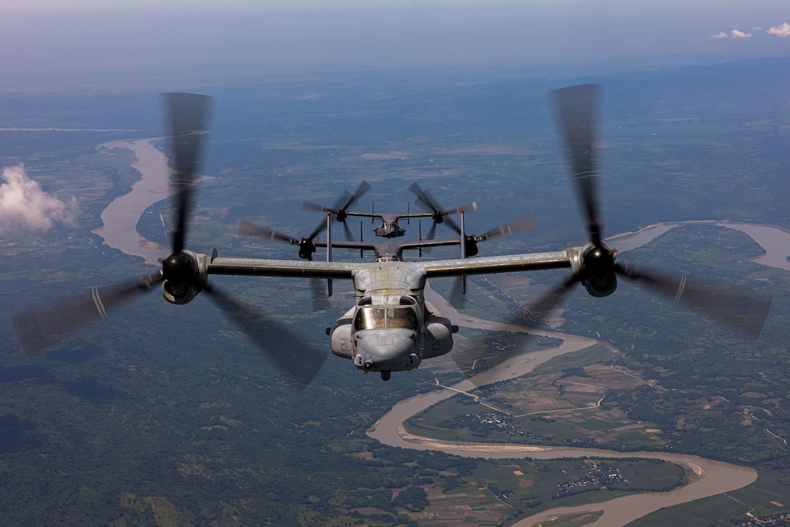 An MV-22B Osprey assigned to Marine Medium Tiltrotor Squadron (VMM) 363, Marine Rotational Force - Darwin 25.3, flies in a formation flight with CV-22 Ospreys assigned to the 21st Special Operations Squadron, 353rd Special Operations Wing, near Lal-lo, Philippines, during a foreign disaster relief operation, Aug. 3, 2025.