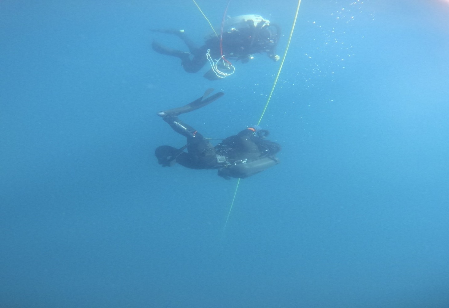 Explosive Ordnance Disposal 1st Class Grant Shaffer and a member of the Japanese Maritime Self Defense Force Explosive Ordnance Disposal detachment conduct a dive on training shapes during Mine Warfare Exercise (MINEX) 2JA near Ominato, Japan, July 21, 2025.