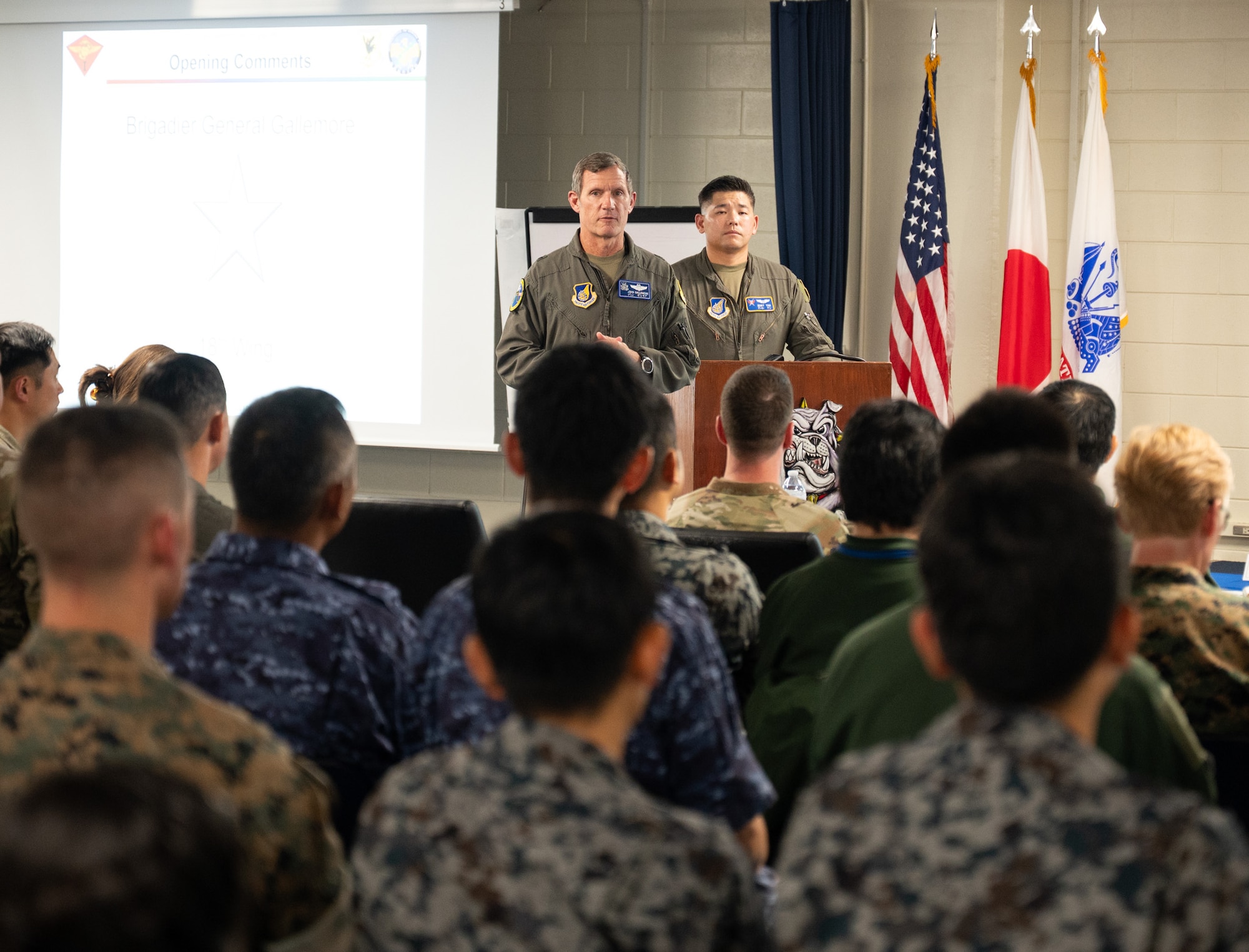 U.S. Air Force Brig. Gen. John Gallemore (Left), 18th Wing commander, and Captain Otto Yan 18th Operations Support Squadron OSK Flight commander, address the audience during the Bilateral Defense of Okinawa Working Group outbrief at Kadena Air Base, Japan, August 1, 2025
